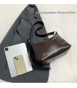 Deep brown wax leather shoulder bag size comparison with tablet and phone