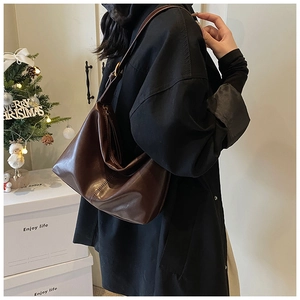 Detail of vintage dark brown faux leather hobo tote bag with adjustable shoulder strap