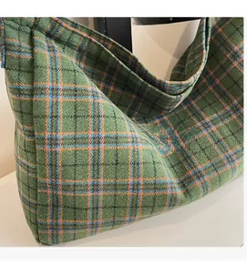 Close-up of green and orange plaid tote bag showing soft wool-like fabric texture