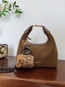 Brown suede hobo handbag with gold nameplate and leopard print plush charm accessories