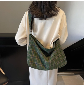 Close-up of the green plaid pattern texture on a large capacity crossbody hobo bag