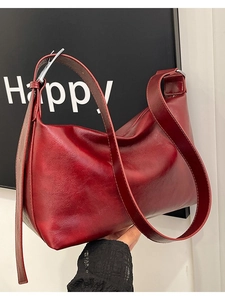 Burgundy hobo shoulder bag in pebbled faux leather with adjustable silver buckle strap