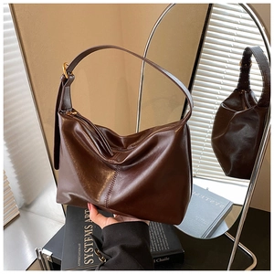 Close-up of a dark brown PU leather hobo tote with a gold adjustable buckle detail