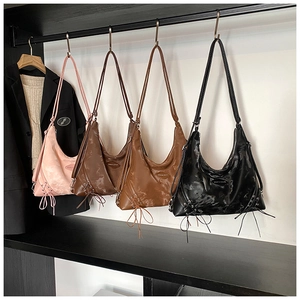 Detail of hobo bags in four colors with decorative drawstring and glossy finish