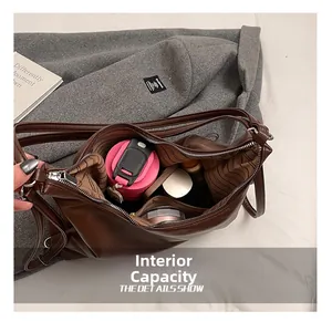 Macro view of the spacious striped interior compartment of the brown leather tote bag