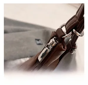Detail of silver zipper and hardware on a high-capacity brown leather tote bag