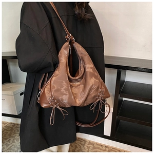 Detailed back view of a large dark brown hobo bag showing soft leather texture and drape