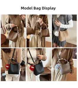 Detailed model lifestyle shot showing various colors of the stylish leather bucket bag
