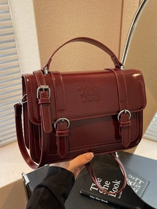 Retro burgundy leather handbag for women featuring a glossy finish and crossbody strap