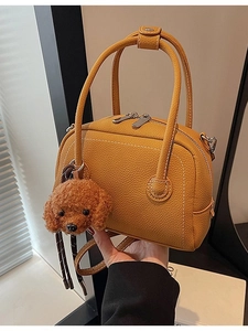 Retro mustard yellow Boston bowling bag with lychee texture and plush dog charm