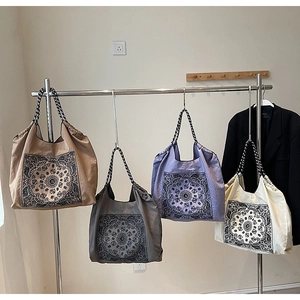 Hanging display of retro bohemian tote bags in khaki, gray, purple and beige colors