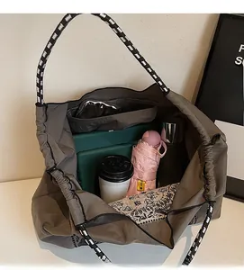 Spacious interior of a vintage tote bag showing room for an umbrella, cup and electronics