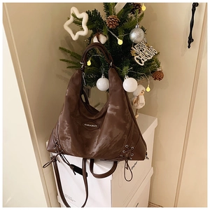 Detail of vintage brown tote bag with marble texture and side drawstring accents