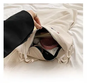 Detailed interior view of the beige pleated shoulder bag showing its spacious inner capacity