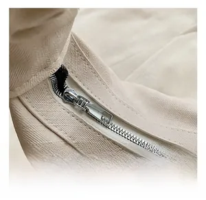 Detailed close-up of premium silver zipper and textured beige leather fabric