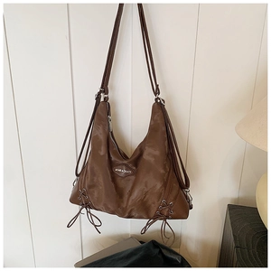 Close-up of brown vintage tote bag with LOVE & CREATE logo and side lace-up detail