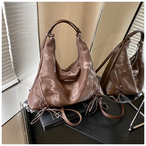 Detail of dark brown marble pattern hobo bag with drawstring base and brand logo patch