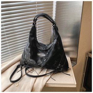 Close-up of a black tote bag with gray cloud texture and side lace-up details