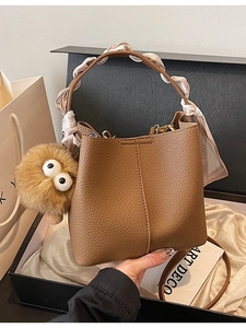 Brown bucket bag with lychee texture, silk scarf handle and plush pendant decoration