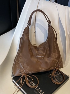 Large brown moon-shaped tote bag with cloud print and cross-lace design details