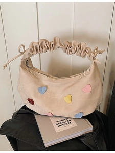 Chic beige shoulder bag with colorful heart patches and pleated cloud handle details