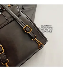 Detail view of adjustable straps with retro gold hardware on leather backpack
