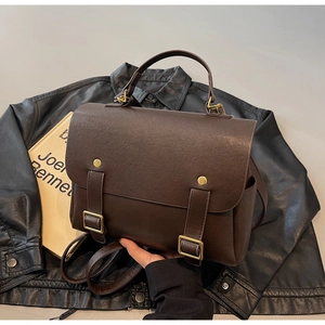 Detailed view of vintage dark brown backpack texture on black leather jacket background