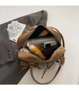 Interior view of brown faux leather tote bag showing large capacity and daily essentials