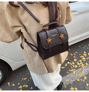 Detailed view of the vintage brown faux leather backpack with gold star buckles