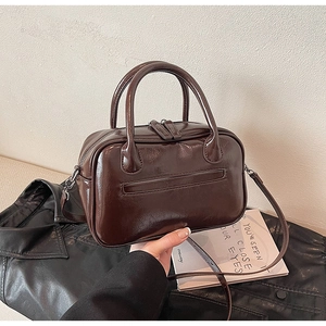 Detail of vintage dark brown oil wax leather Boston handbag with dual top handles