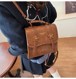 Brown vintage faux leather backpack featuring star accents and adjustable straps