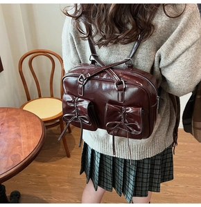 Detail view of deep red vintage backpack with bow-knot pockets in retro interior setting
