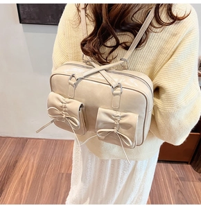 Detail of a creamy glossy faux leather backpack with double bow accents and ruffles