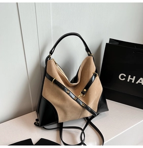 Detail of khaki suede and black leather stitching on large tote with gold hardware