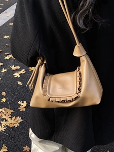 Caramel leather shoulder bag with ruffled flap design for autumn fashion look