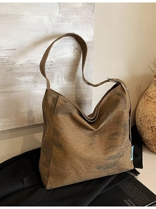 Vintage brown canvas hobo tote bag with metal eyelet strap and slouchy design