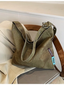 Olive green large canvas hobo tote bag with silver eyelets and adjustable strap