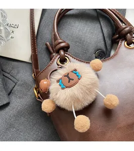 Close-up of brown leather bucket bag featuring a cute oversized plush cartoon charm detail