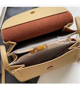 Detail of premium beige bag showing smooth zipper pocket and herringbone lining