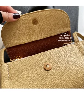 Detail of lychee pattern leather bag with strong magnetic buckle for easy closure