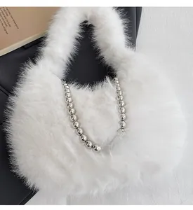 Close-up of white faux fur handbag texture with decorative silver metallic beads