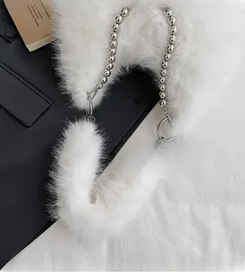 Detailed shot of white plush crescent bag with chunky silver metallic bead chain