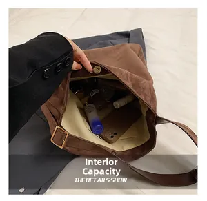 Top view showing the internal capacity and magnetic closure of the brown suede tote bag