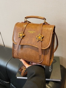Brown leather backpack with golden star buckles and vintage square flap design