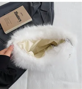 Detail view showing spacious interior lining and silver zipper of white plush shoulder bag