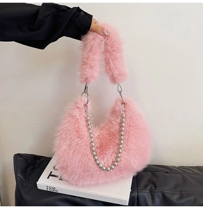 Detail of pink faux fur hobo bag featuring plush handle and decorative silver bead chain
