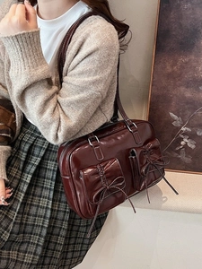 Retro burgundy faux leather shoulder bag with decorative bows and front pockets