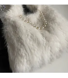 Close-up of fluffy white faux fur texture and large pearl handle with metal clasps