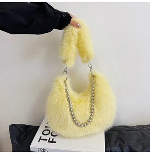 Detail of soft yellow faux fur handbag with silver beaded chain and plush handle