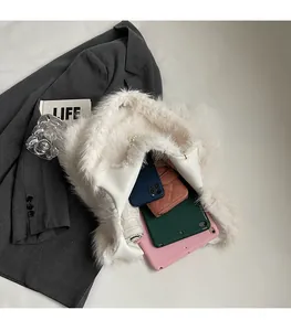 Spacious white faux fur tote bag showing interior storage for tablet and daily items